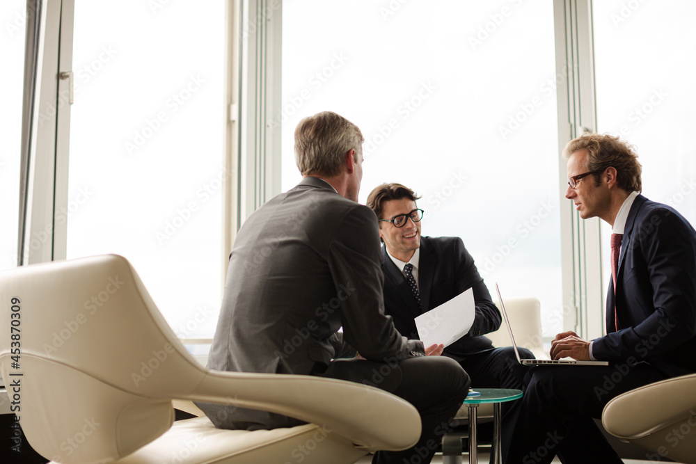 Businessmen sitting in meeting Businessmen sitting in meeting