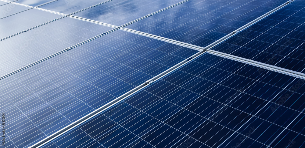Photovoltaic roof with reflection of the Sunlight and clouds on the surface. Photovoltaic roof with reflection of the Sunlight and clouds on the surface.
