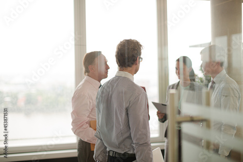 Business people talking in office hallway