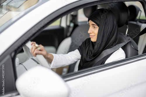 Muslim woman drives a car photo