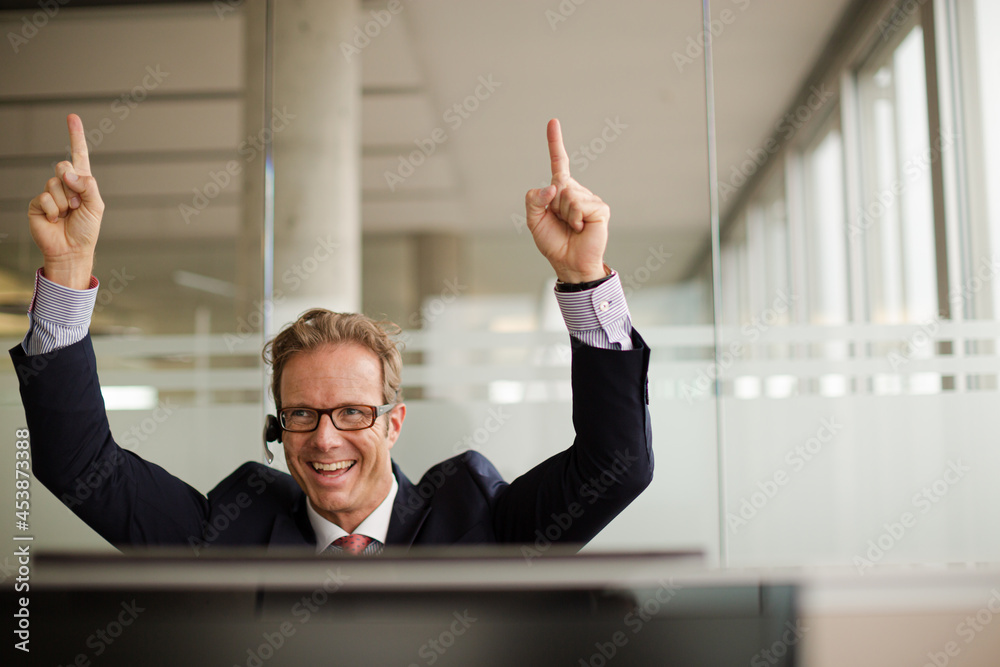 Businessman talking on headset in office Businessman talking on headset in office