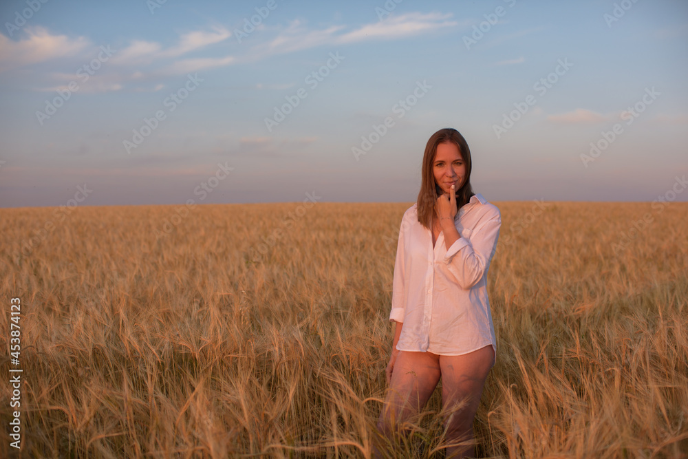 Aerial view of woman lying in the yellow field of wheat Aerial view of woman lying in the yellow field of wheat