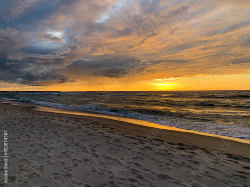Peaceful sunset at the sea  sand beach  yellow orange sunset
