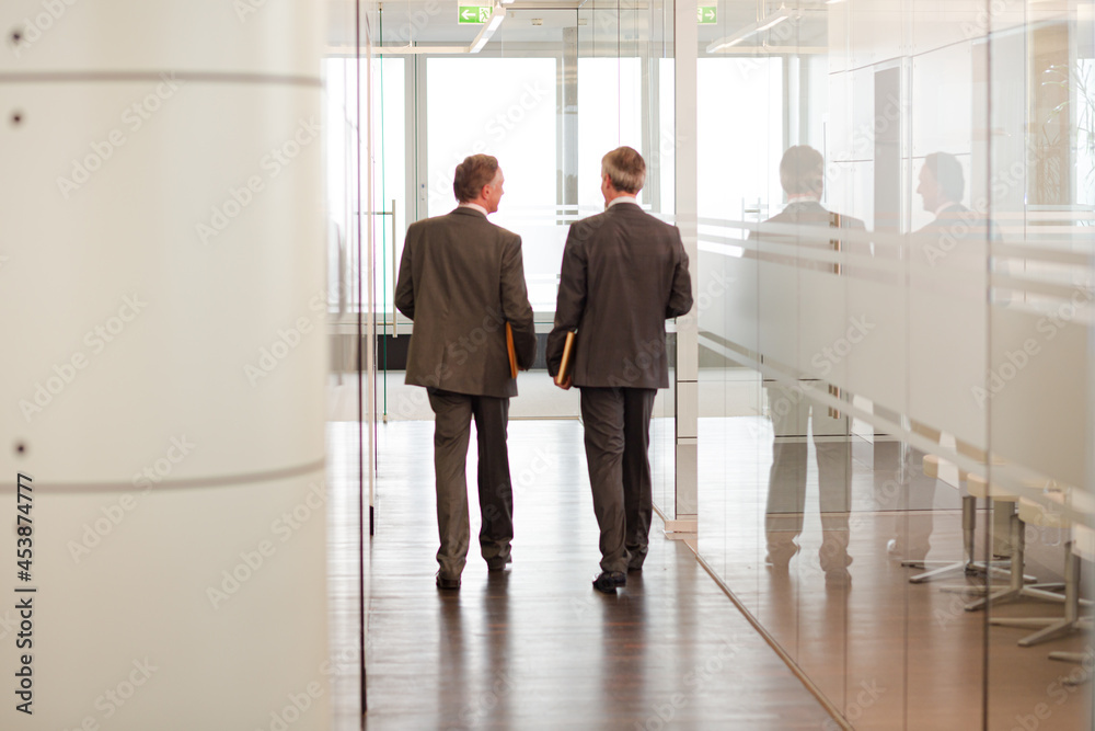 Businessmen talking in office area