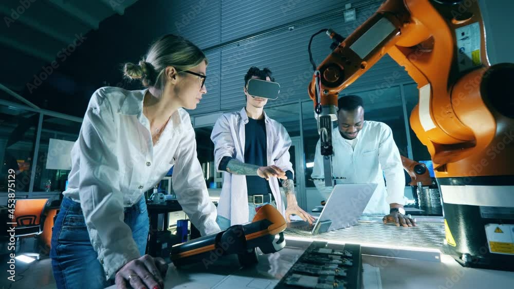 Team of IT engineers are using VR-glasses to operate robots