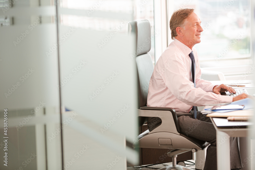 Businessman sitting at desk in office