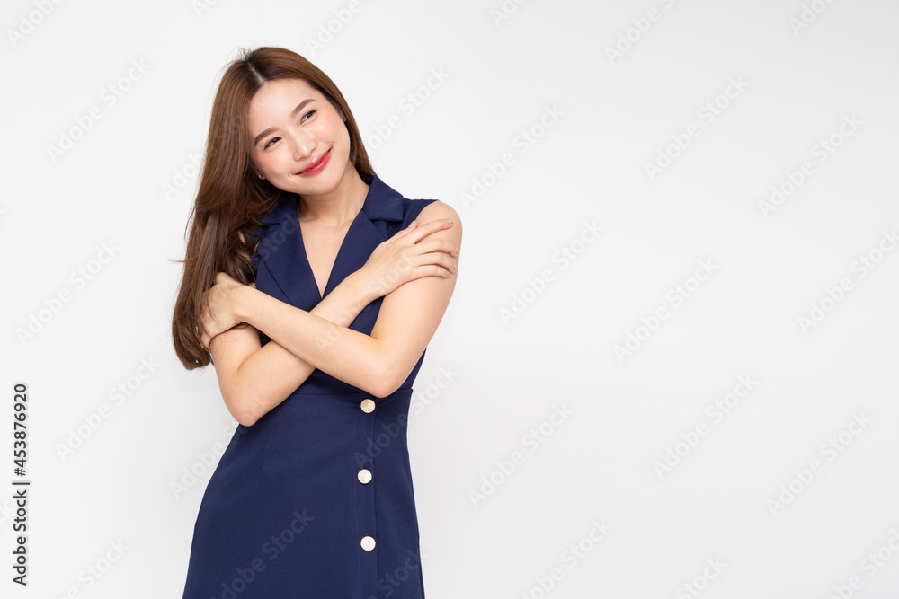 Charming young beautiful Asian woman hugging and embracing herself isolated on white background. Love appreciation and self care concept Charming young beautiful Asian woman hugging and embracing herself isolated on white background. Love appreciation and self care concept