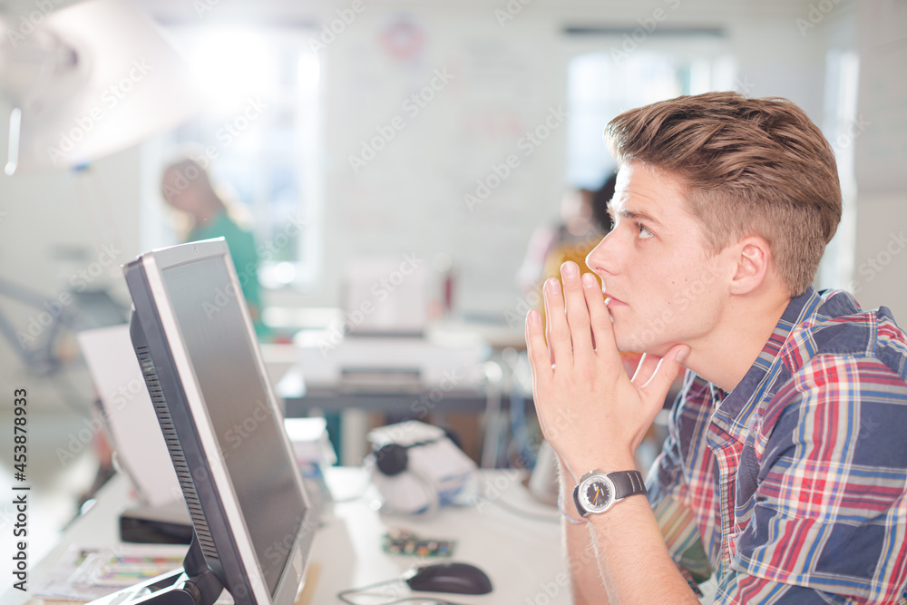 Businessman working at computer at desk Businessman working at computer at desk