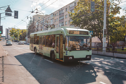 A trolleybus rides along a summer street in Minsk