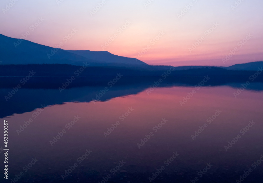 Hazy purple sunset over Lake McDonald in Glacier National Park, MT