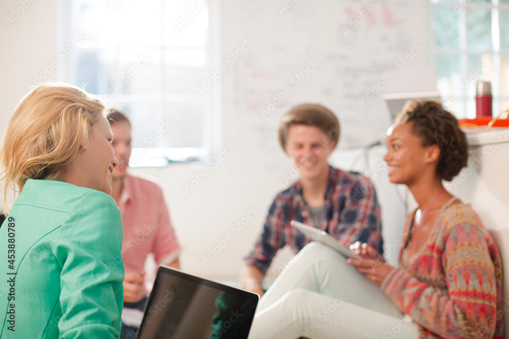Business people talking on floor in office