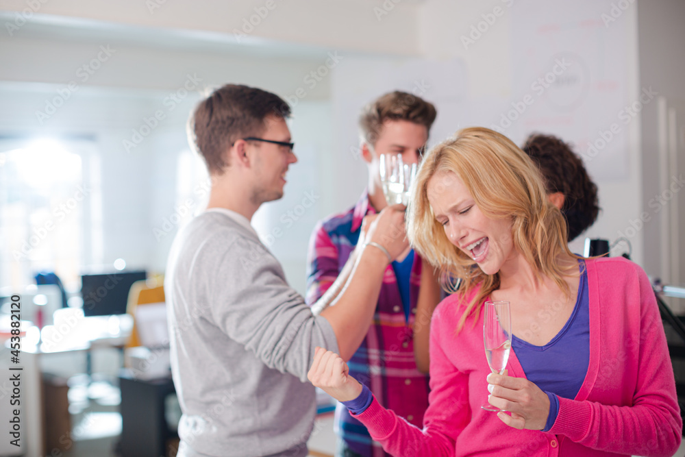 Businesswoman celebrating in office