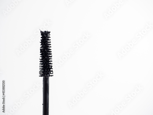Close-up of a black eyelash brush on a white background. Copy space