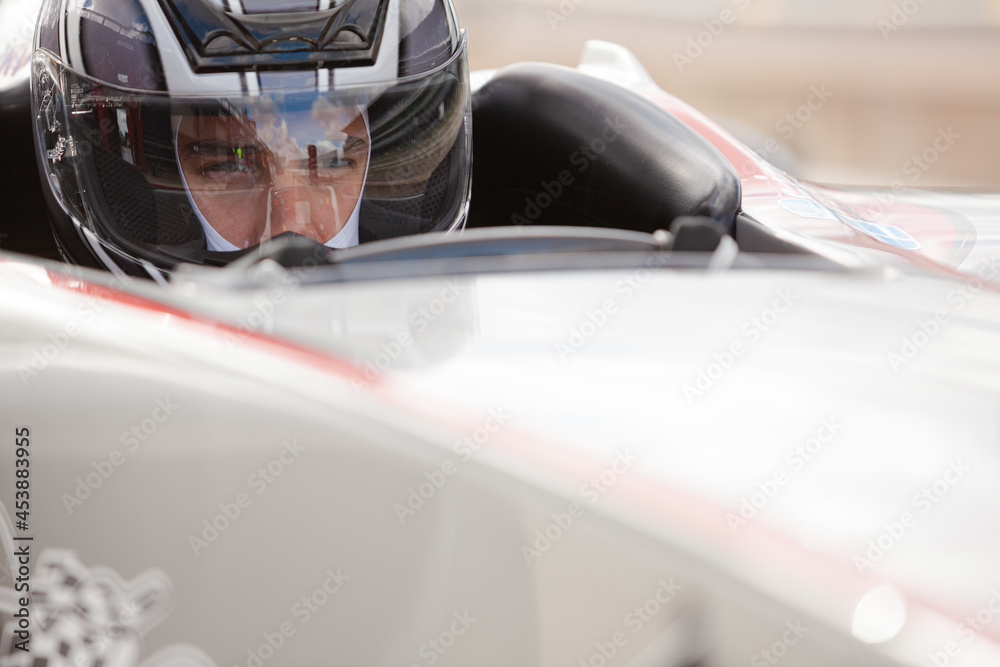 Close up of racer wearing helmet
