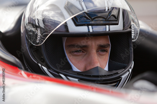 Fototapeta Close up of racer wearing helmet