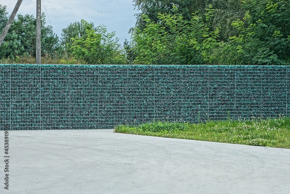 custom made wallpaper toronto digitallong gray green wall of a fence made of metal lattice and pieces of glass on the street