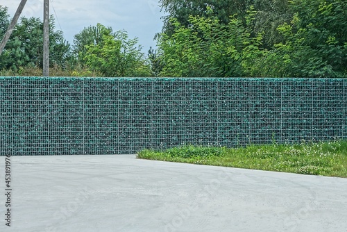 Wallpaper Mural long gray green wall of a fence made of metal lattice and pieces of glass on the street Torontodigital.ca