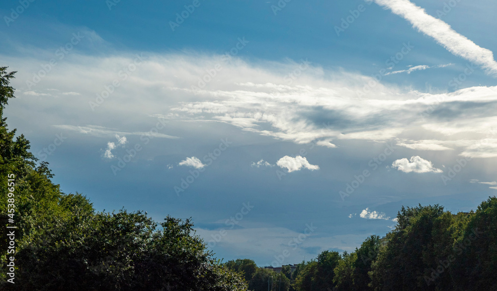 Landscape with dramatic sky and unripe wheat field at rainy summer season. Dirt road with dark storm clouds Landscape with dramatic sky and unripe wheat field at rainy summer season. Dirt road with dark storm clouds