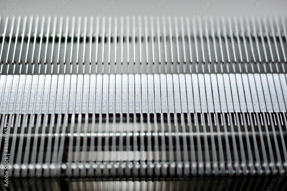 Silver aluminum CPU radiator with copper cooling tubes close-up Silver aluminum CPU radiator with copper cooling tubes close-up