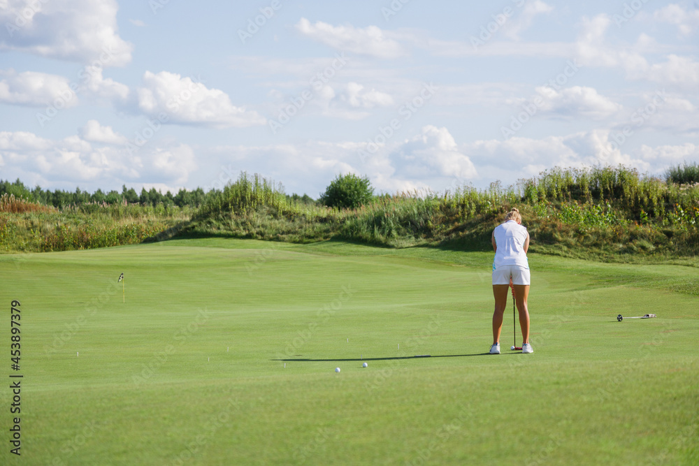 Beautiful tanned golfer girl on the golf course. Beautiful tanned golfer girl on the golf course.