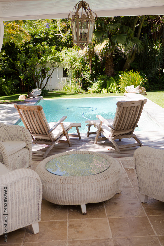 Lawn chairs and swimming pool in backyard Lawn chairs and swimming pool in backyard