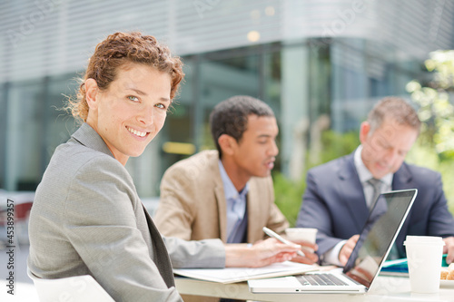 Businesswoman smiling in meeting outdoors