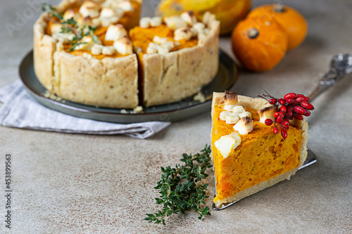 Thanksgiving Day pumpkin, feta cheese and thyme savory pie. Fall traditional homemade pumpkin pie for autumn holiday.