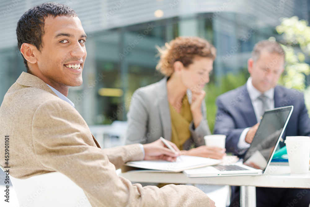 Businessman smiling in meeting outdoors Businessman smiling in meeting outdoors