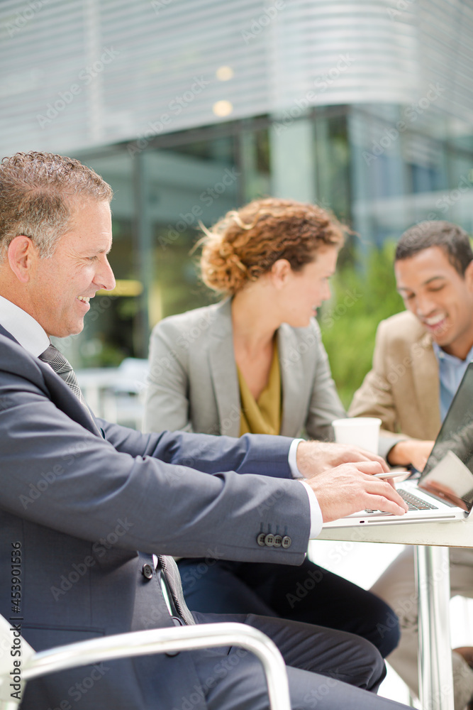 Business people talking in meeting outdoors Business people talking in meeting outdoors