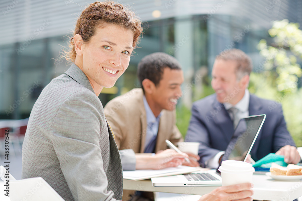 Businesswoman smiling in meeting outdoors Businesswoman smiling in meeting outdoors
