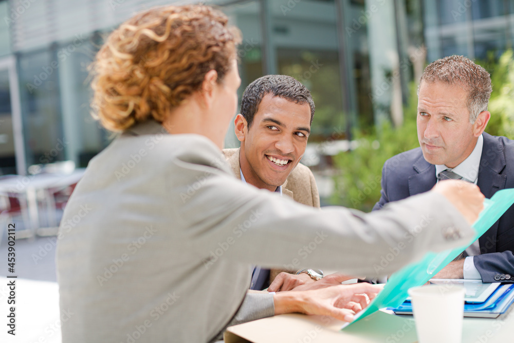 Business people talking outdoors Business people talking outdoors
