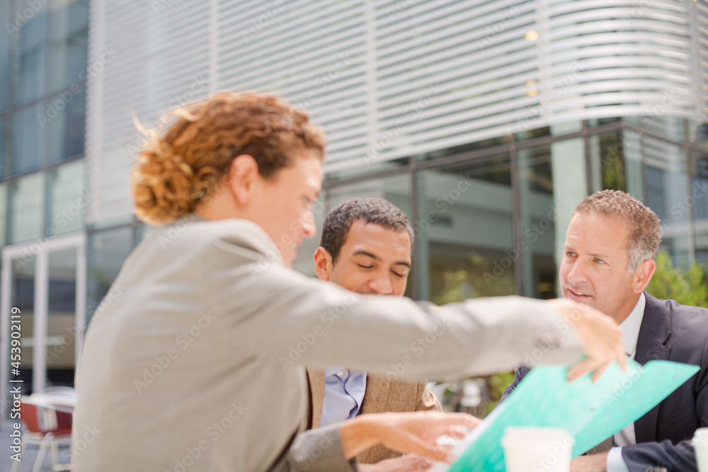 Business people talking outdoors Business people talking outdoors