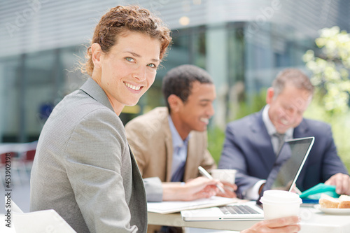 Businesswoman smiling in meeting outdoors
