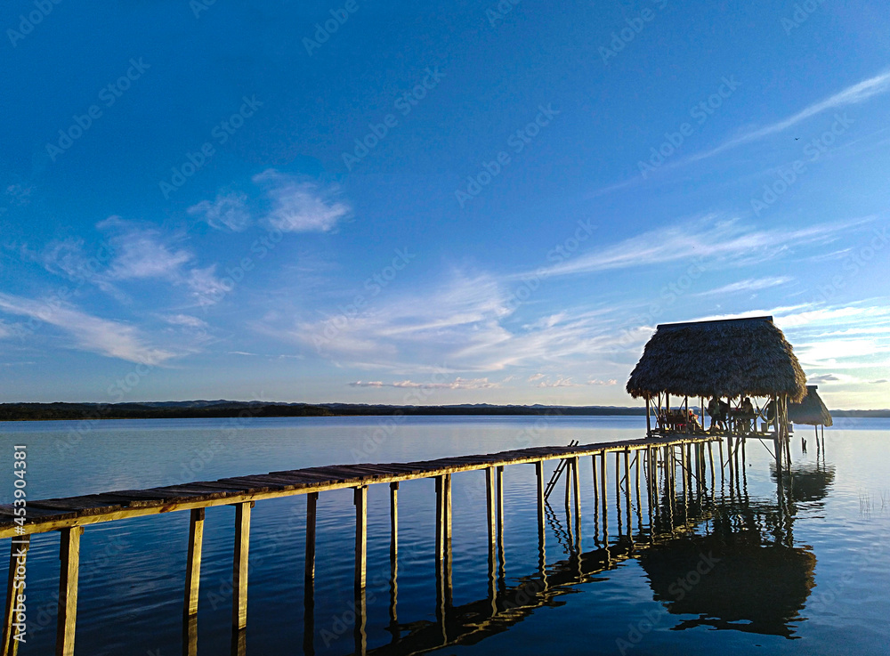 Impressive Lake Petén Itza in El Remate Guatemala. View of a pier at sunrise with beautiful sky Impressive Lake Petén Itza in El Remate Guatemala. View of a pier at sunrise with beautiful sky