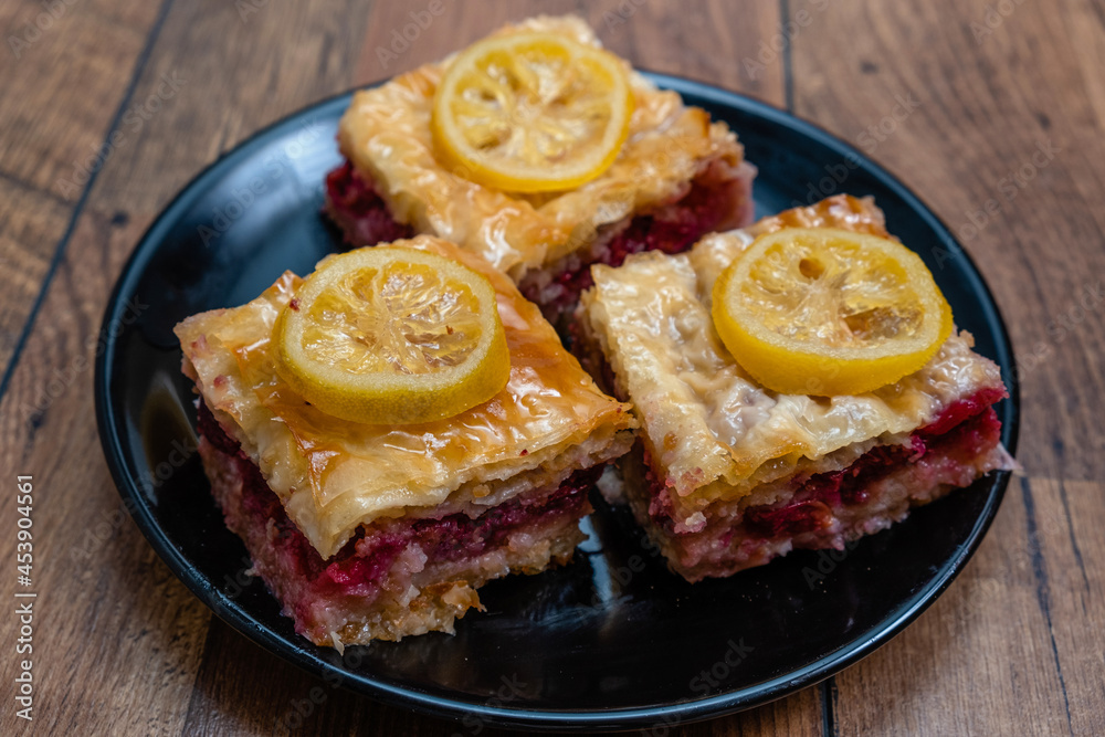 Homemade sweet pastry made of layers of filo filled with chopped nuts, cherry and sweetened and held together with syrup or honey. Homemade sweet pastry made of layers of filo filled with chopped nuts, cherry and sweetened and held together with syrup or honey.