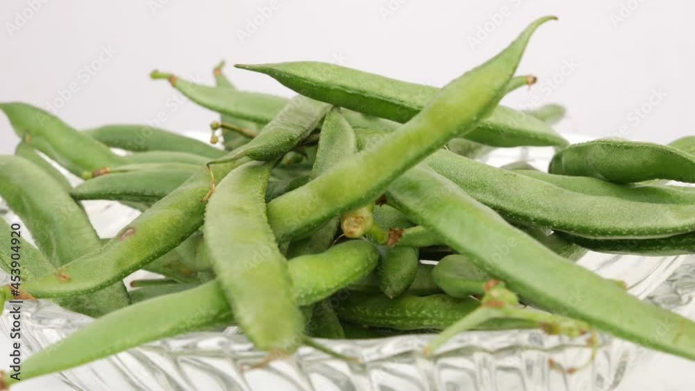 Close shot of transparent glass bowl containing green beans Close shot of transparent glass bowl containing green beans