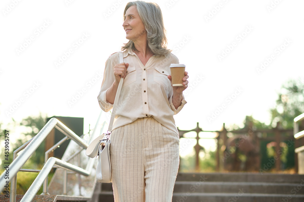 Woman with coffee looking to the side Woman with coffee looking to the side