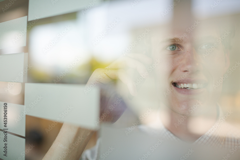 Businessman talking on cell phone at office window Businessman talking on cell phone at office window