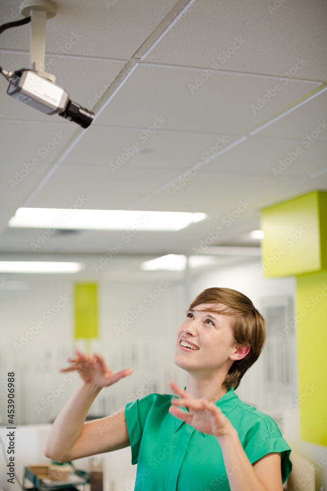 Businesswoman making face at security camera Businesswoman making face at security camera