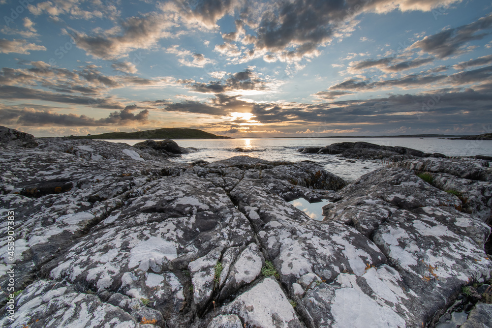 sunset over the ocean horizon on a warm summers evening near sky road in Connemara.