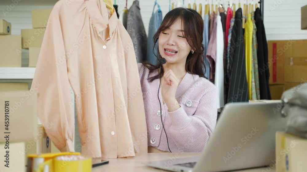 business online,POV Asian woman influencer seller broadcast live streaming to sell clothes for online social marketing
