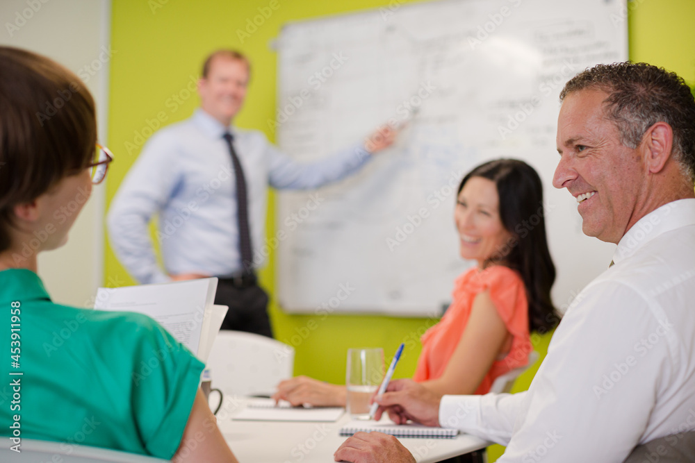Businessman drawing on whiteboard in meeting Businessman drawing on whiteboard in meeting