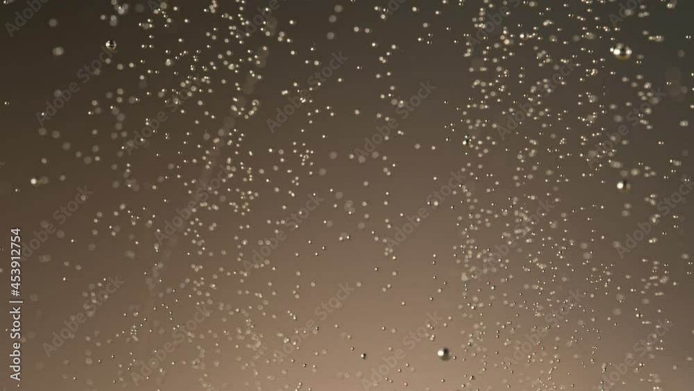 Super slow motion of champagne bubbles going up. Macro shot, filmed on high speed cinematic camera at 1000 frames per second.
