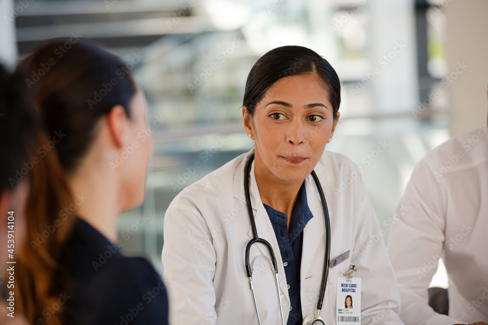 Doctors and businesswoman talking in meeting Doctors and businesswoman talking in meeting