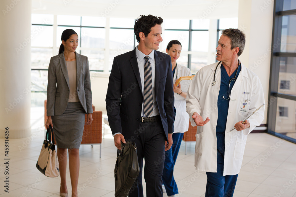 Doctors talking in hospital corridor Doctors talking in hospital corridor