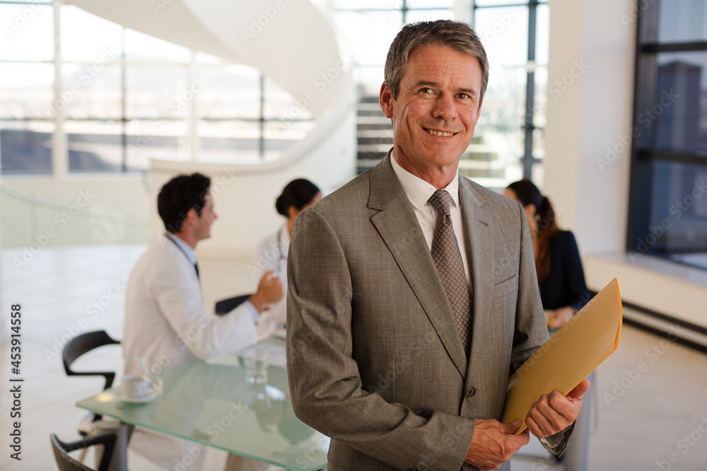 Doctor and senior patient talking in hospital room