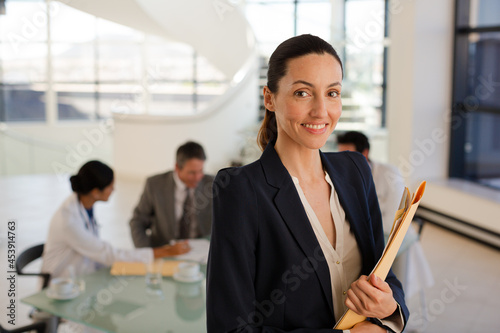 Photography Portrait of smiling businesswoman in meeting with doctors