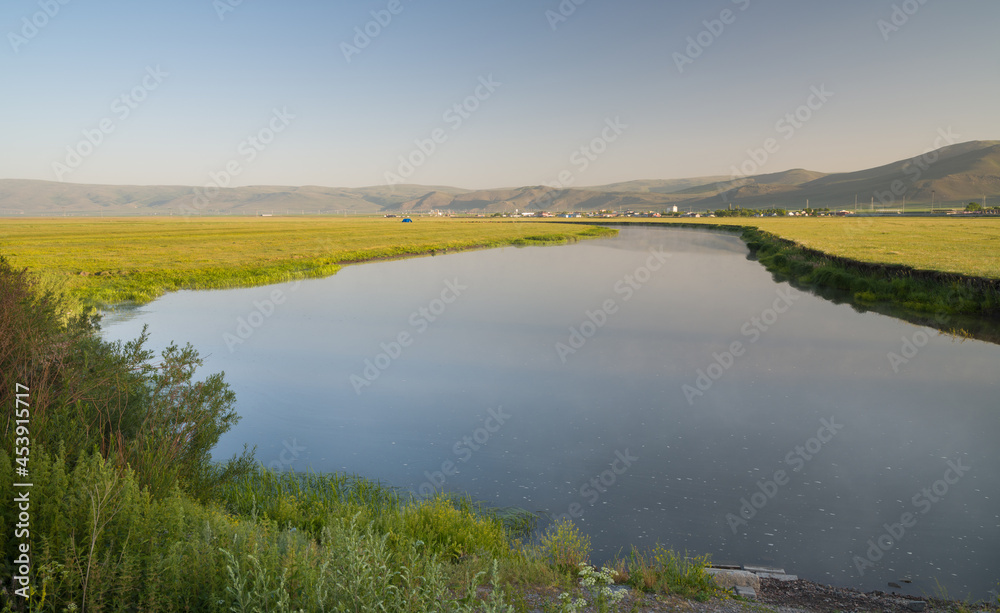 Panorama of a spring landscape with sunrise, fog and the river