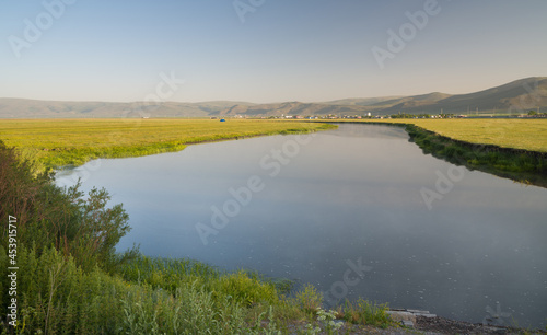 Panorama of a spring landscape with sunrise, fog and the river © daphnusia