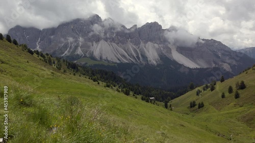 View of alpine meadows with Oddle Gruppa mountains in the Dolomites, Italy photo